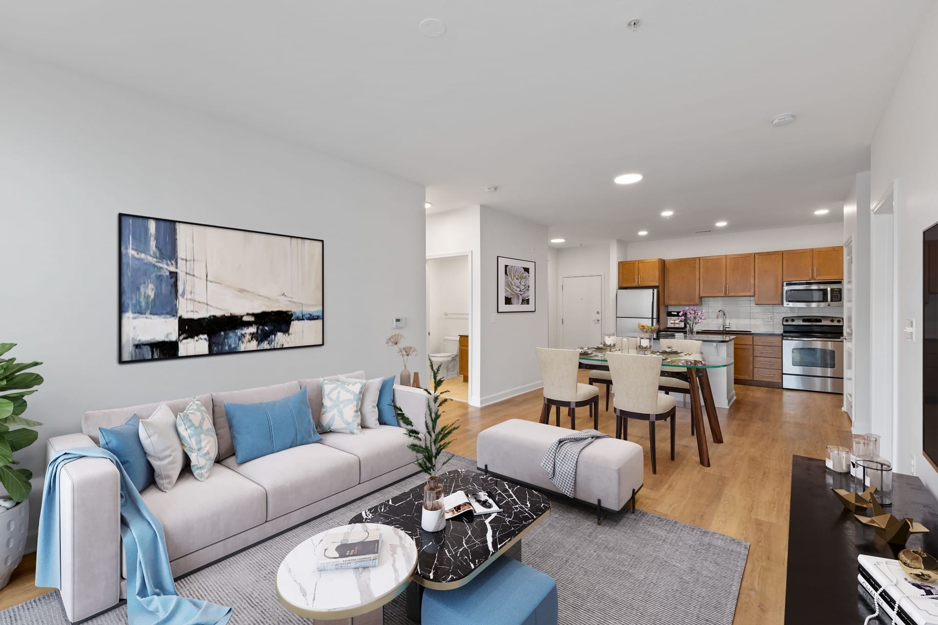 a living room with a couch and a table and a kitchen