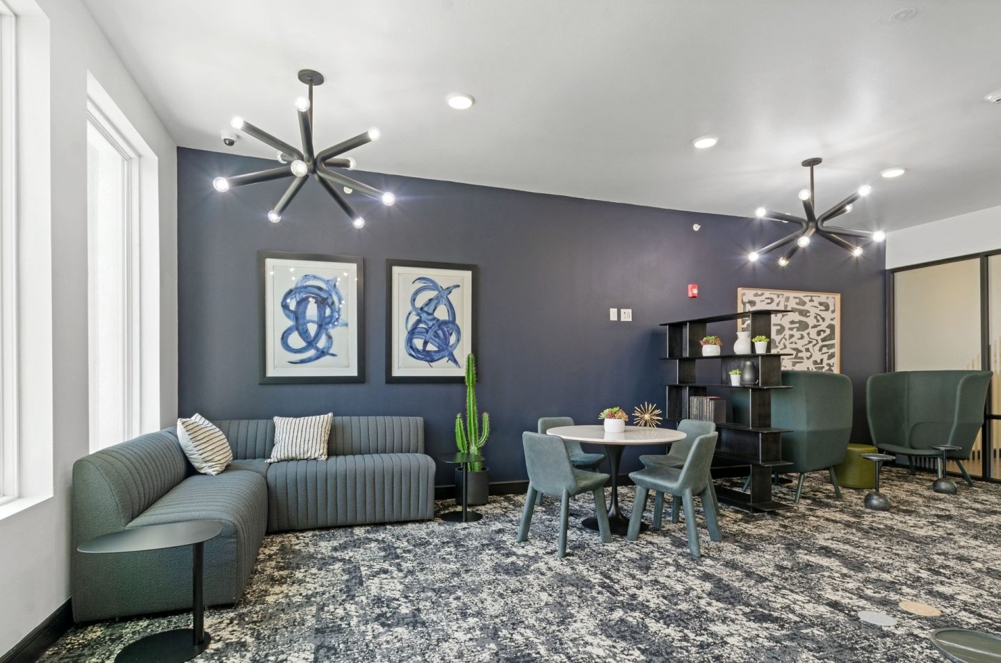 a living room with blue walls and a table and chairs