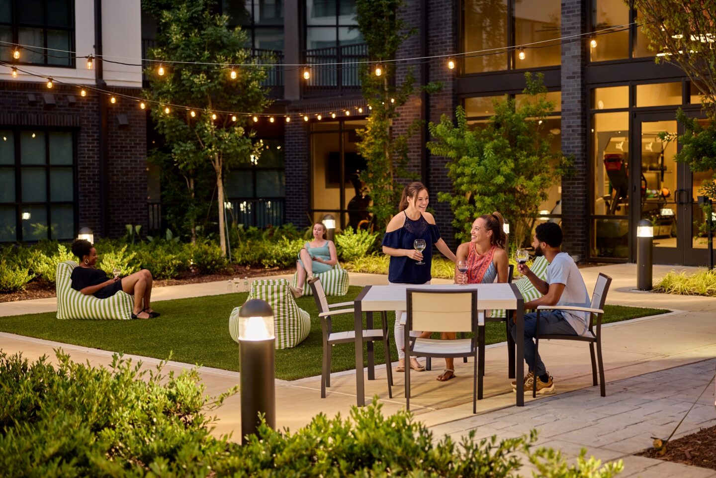 friends gathering in outdoor apartment community space