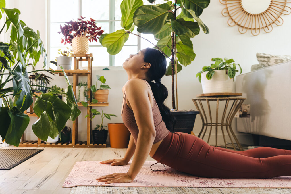 young woman doing yoga in her apartment