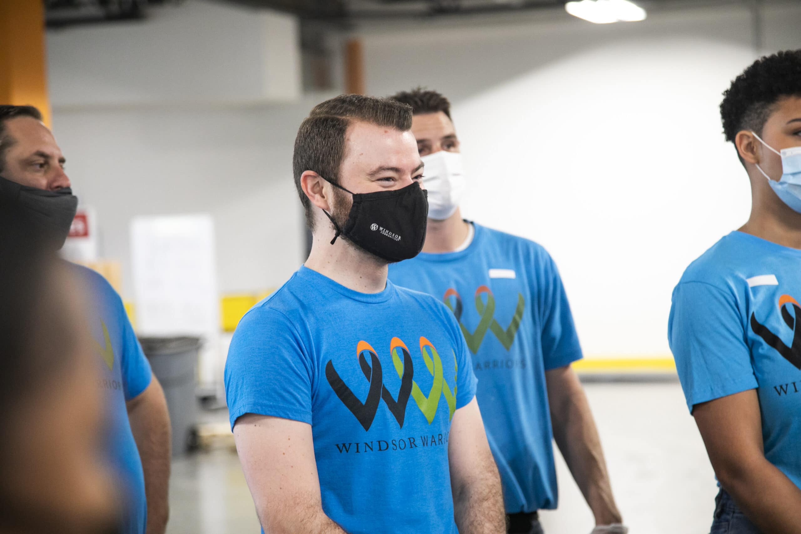 group of professionals with masks working together