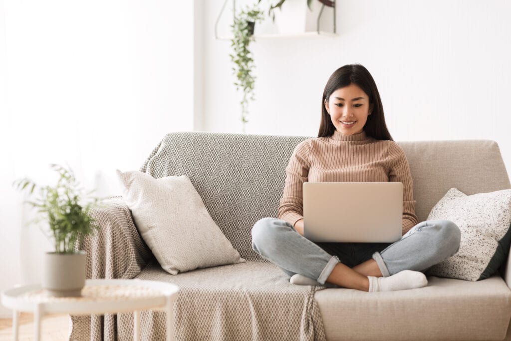woman on couch with laptop