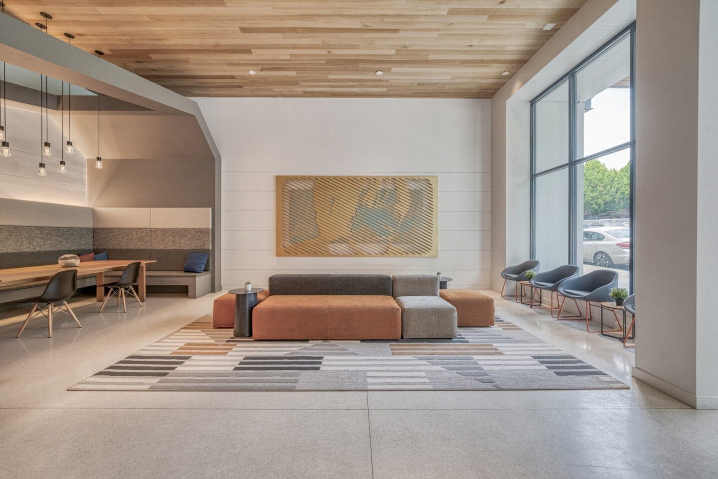 A seating area with a couch and chairs in front of a large window at Windsor Buckman, Portland, Oregon