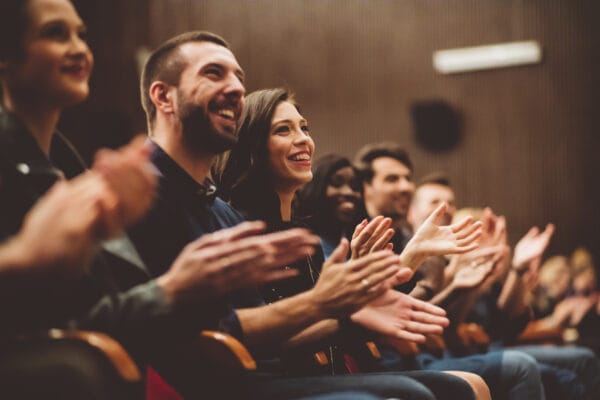 Happy audience applauding in the theater