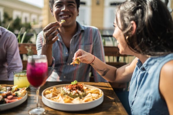 Friends eating guacamole at a restaurant