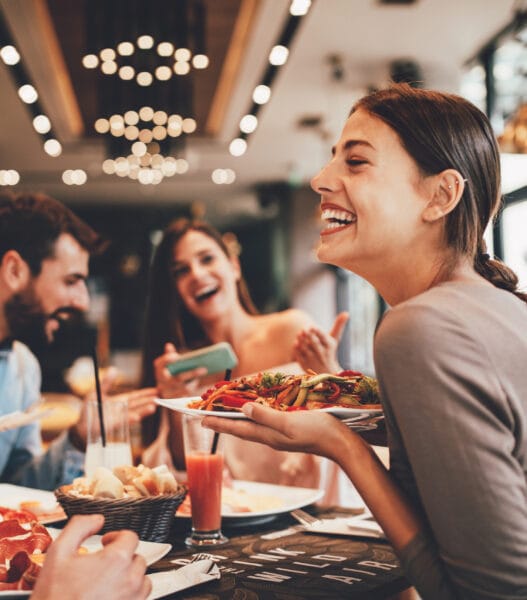 Group of Happy friends having breakfast in the restaurant