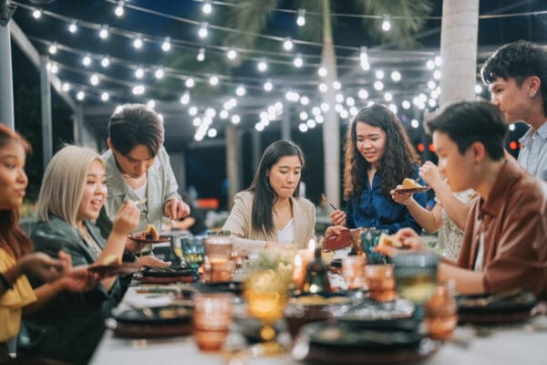 Asian Chinese Lesbian Couple celebrating birthday outdoor dining with friends