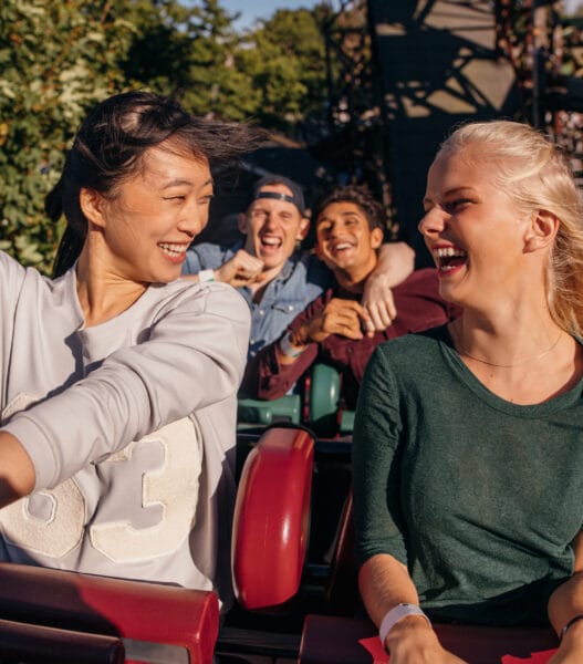 Friends enjoying and cheering on roller coaster