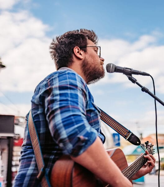 Guitar Player On A City Square