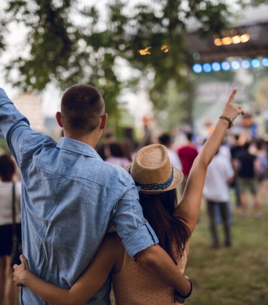 Couple toasting on a music festival